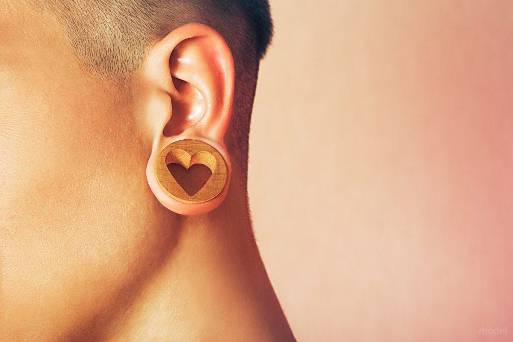 close-up of a heart-shaped ear gauge