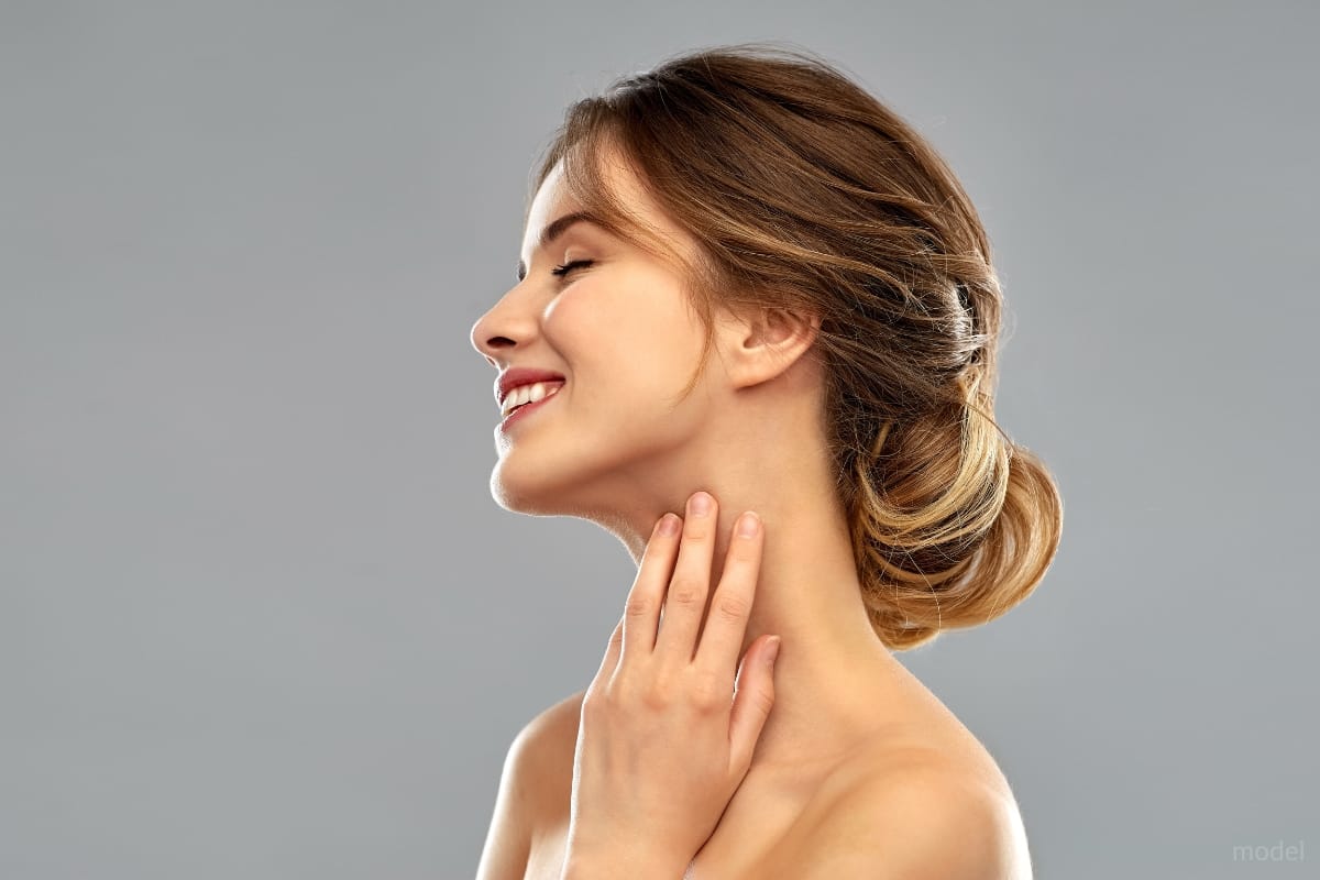 woman with beautiful facial features smiling with her eyes closed